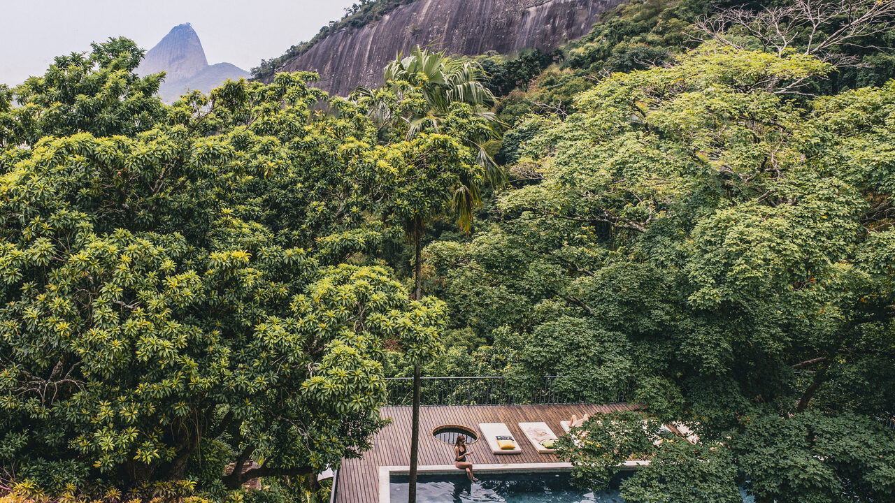 Pool terrace surrounded by rainforest with Sugarloaf beyond