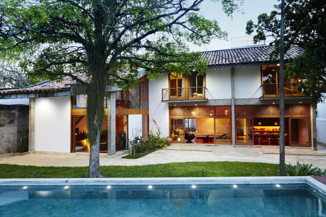 Modernist villa and pool at dusk